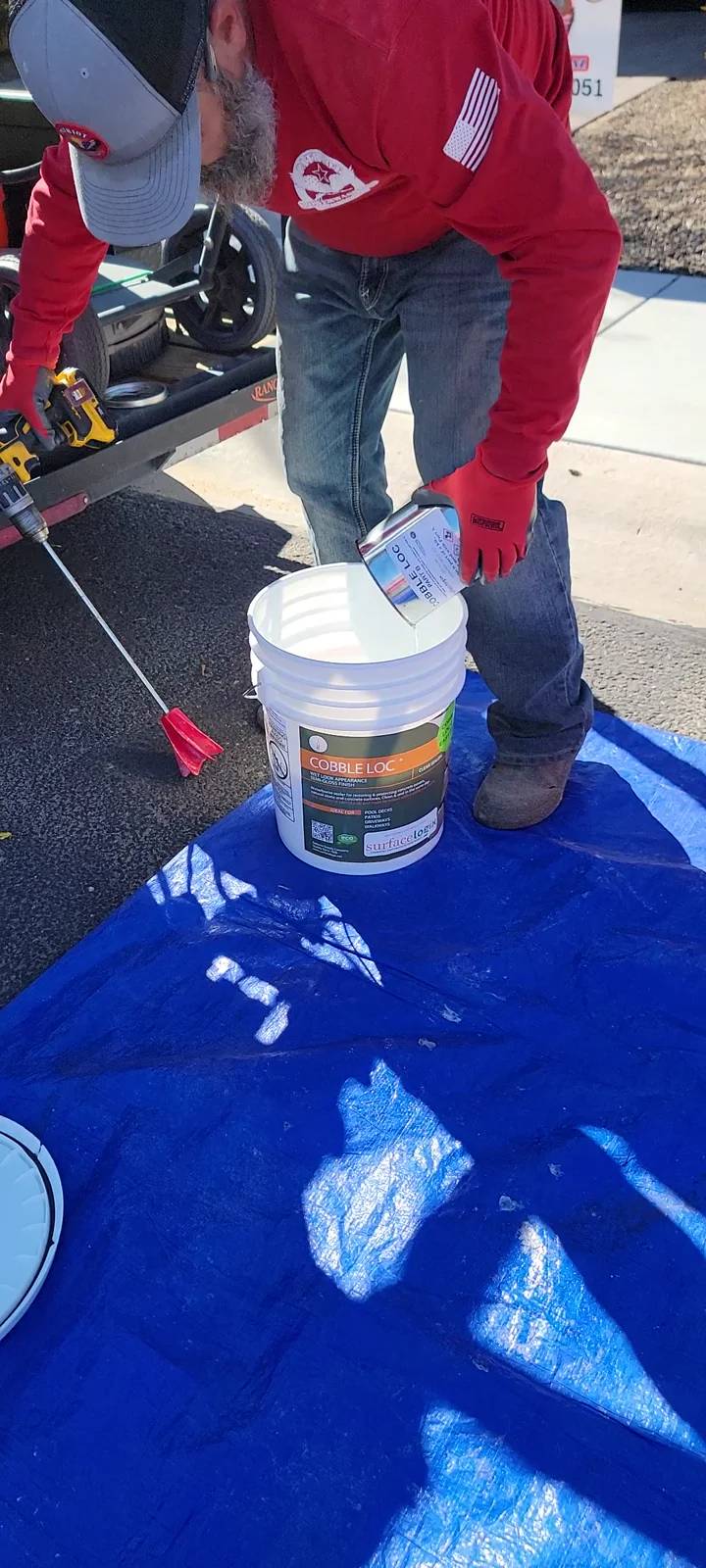 Mixing SurfaceLogix CobbleLoc with a drill mixer during a Patriot project